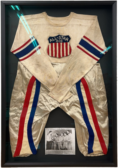 Vintage American all-star sports uniform in a black shadowbox frame. A small newspaper clipping on bottom